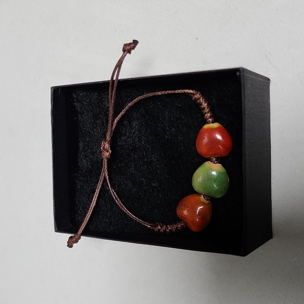 Adjustable friendship/love bracelet made of beads and waxed string with box.